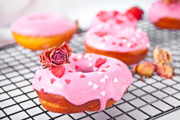 Pink doughnuts on the baking rack. Valentine's Day concept.