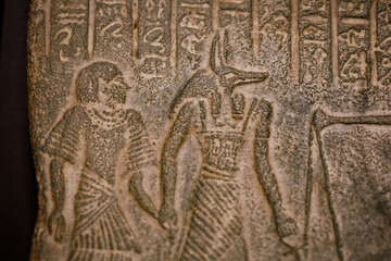 Shallow depth of field (selective focus) and close up footage with Egyptian hieroglyphs on a historic replica.