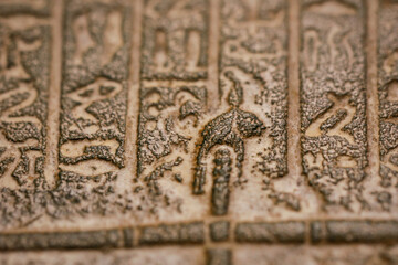Shallow depth of field (selective focus) and close up footage with Egyptian hieroglyphs on a historic replica.