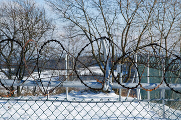 restricted area barbed wire fence in winter