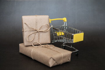 Season of sales in online stores. Cart and sales word on dark blue background. Creative idea for a...