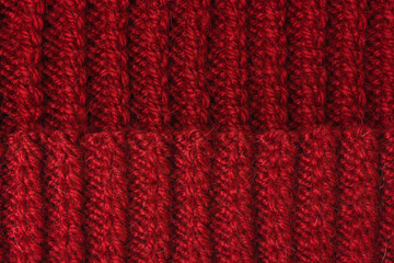 Knitting canvas texture. Red or burgundy color. Edge, seam