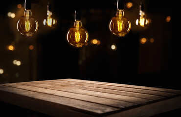 Dark empty room, wooden table, blurred walls, lamps view at night