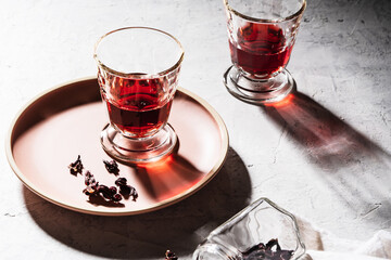 Hibiscus tea and dry rose petals, hard light with harsh shadows