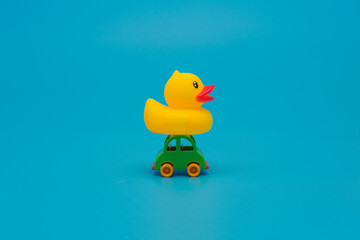 Toy car carrying yellow duck. Toy donation and delivery concept