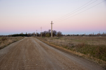 Dirt road with power lines going into the distance at sunset, Kacha, Sevastopol, Crimea, Russia
