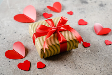Fototapeta premium Gift Present box of craft paper with red ribbon, red hearts. Valentine's Day concept.