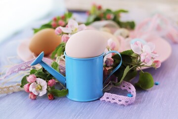 Eggs, Easter decorations, apple-tree flowers on a wooden surface by the window