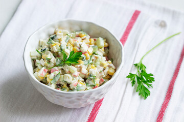 Vegetable salad with crab sticks, dressed with mayonnaise.