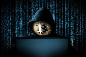 hacker with bitcoin face mask behind notebook laptop front of blue source binary code background...