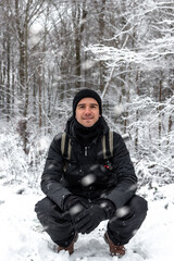 Fototapeta na wymiar young man enjoying a snowy forest