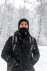 Fototapeta na wymiar young man enjoying a snowy forest