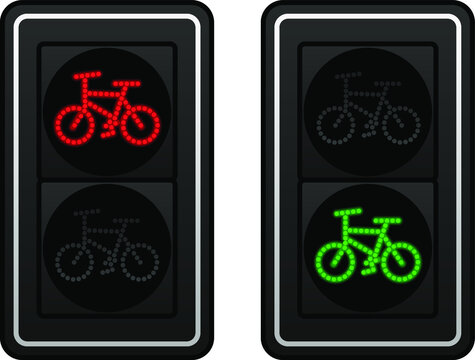 Two sets of LED bicycle lane traffic lights showing red or green lights.