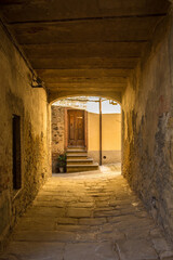 Fototapeta na wymiar A covered alley in the village of Montemerano near Manciano in Grosseto province, Tuscany, Italy 