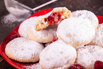Traditional Christmas cookies biscuits snowballs covered icing sugar povder with almond nut, nutella chocolate an raspberry jam. Christmas New Year ornament decorations.
