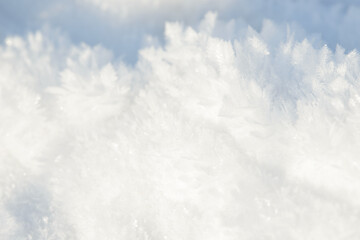 Hoarfrost background texture. Fresh ice and snow winter backdrop with snowflakes and mounds. Seasonal wallpaper. Frozen water geometrical shapes and figures. Cold weather atmospheric precipitation.