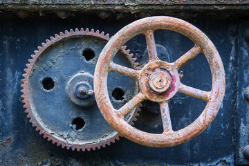 Fototapeta na wymiar Rusty control wheel on an abandoned machine