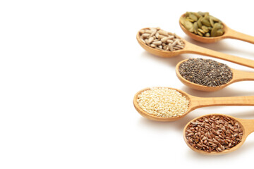 Healthy superfood: sesame, pumpkin seeds, sunflower seeds, flax seeds and chia isolated on white. Seeds on spoon