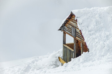 Minimalist winter landscape with wooden house in snowy mountains. landscape photography