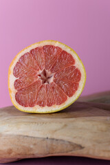 Fototapeta na wymiar half a grapefruit on a wooden background