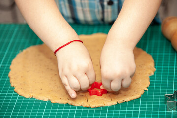 Obraz na płótnie Canvas kids hands making dough cookies