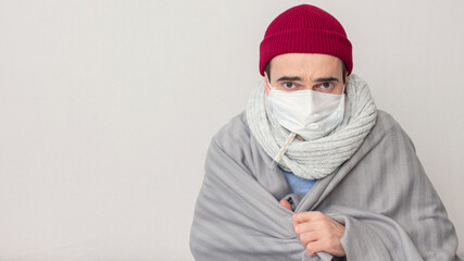 Sick man measures the temperature, toned, portrait