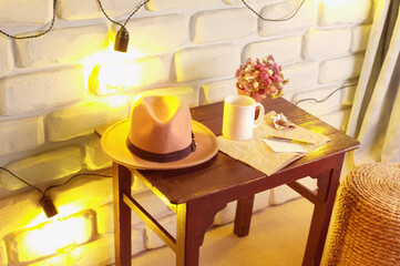 Home staging with white brick wall, table and yellow lamps