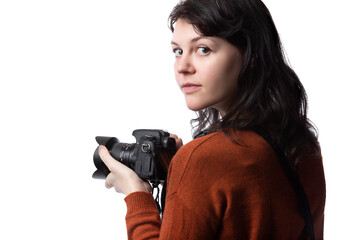 Side view of a female photographer holding a camera isolated on a white background for composites.  The model is posed to face a scenery or copy space