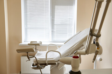 Gynecological chair in the clinic. gynecology room, medical instruments, interior of the genicology...