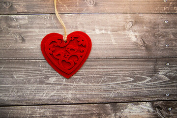red felt heart on a wooden background. valentine's day