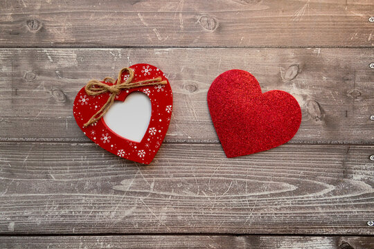 two red hearts on a wooden background. valentines day background