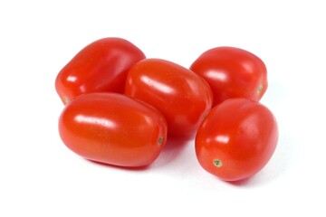 Close up of three red small cherry tomatoes on a white background.
