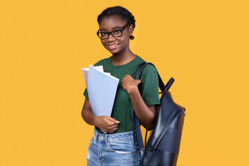 Cheerful African American Female Student Posing Standing Over Yellow Background