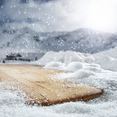 Wooden old table covered with snow against the background of a beautiful winter landscape in picturesque unusual places.
