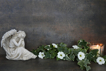 Angel figure with flowers and candle