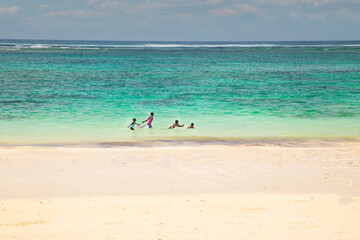 Fototapeta na wymiar Children playing at the beach.