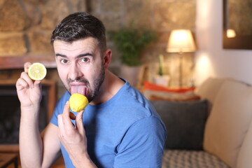 Man tasting a raw lemon