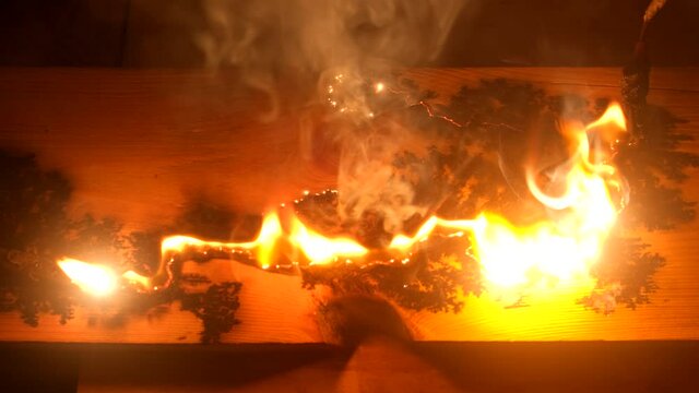 The fire burns on the board after a short circuit. Lichtenberg figures. Wood engravings.