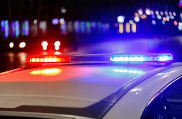 police car lights at night in city with selective focus and bokeh