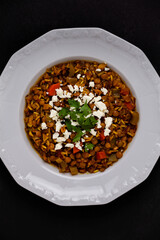 Green lentil soup dish flat lay. Lentil soup with rice, carrot and celery in a plate.