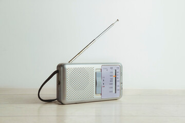 Old radio with the antenna deployed on a white background. Radio day. Vintage style.