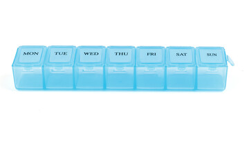 Blue plastic organizer, for pills isolated on white background. Close-up on compartments pill case with clip lids medicine. Daily vitamins and supplements dosage routine concept.