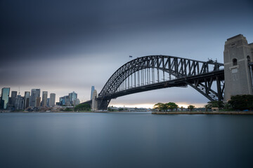 Sydney Harbour Bridge moody long exposure with smooth water and skyline