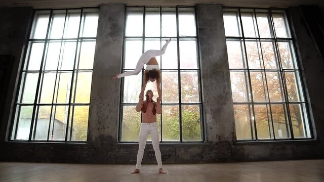 Circus artists making acrobatic tricks as a couple. Concept of healthy lifestyle 