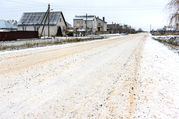 Fototapeta premium The road is cleared of snow and sprinkled with salt and sand for safe movement.