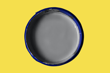 Can with paint of ultimate gray color on illuminating yellow background.