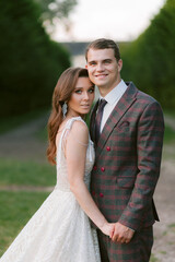 The portrait of stunning bride and smiling groom. Happy newlyweds. Wedding couple. Wedding photo