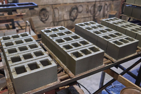 Cinder blocks lie on the ground and dried.