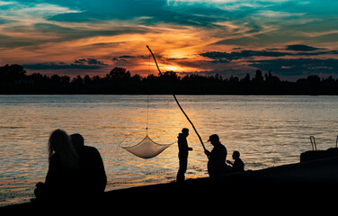 Riga, Andrejsala, Fisherman at sunset