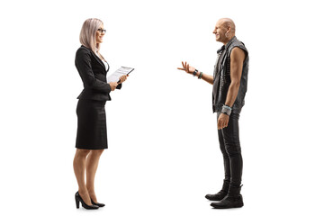 Businesswoman having a conversation with a bald punk